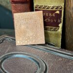 Antique books with decorative copper plate.