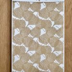 Textured leaf pattern sample on card.