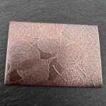 Copper sheet with leaf patterns embossed.
