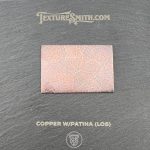 Copper sample with patina on black background.