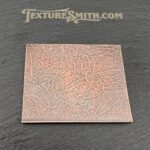 Textured copper plate on black background.