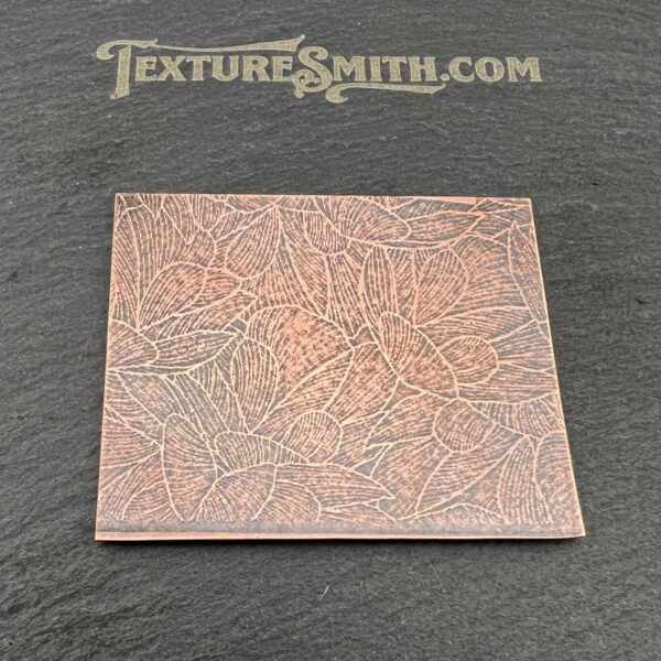 Textured copper plate on black background.