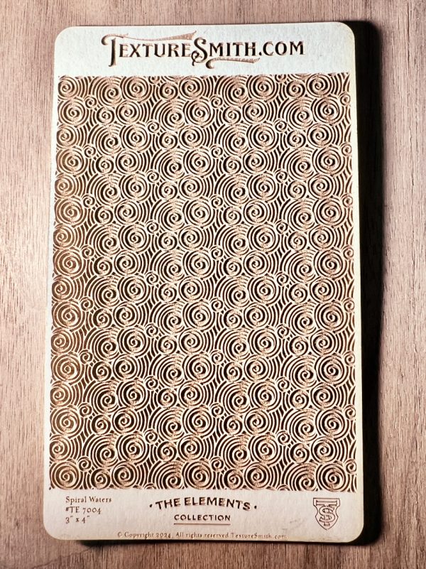 Wooden card with intricate spiral design.
