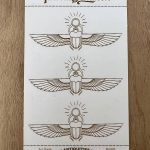 Three scarab beetles with wings design.