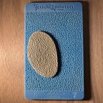 Blue and beige textured sample on wood.