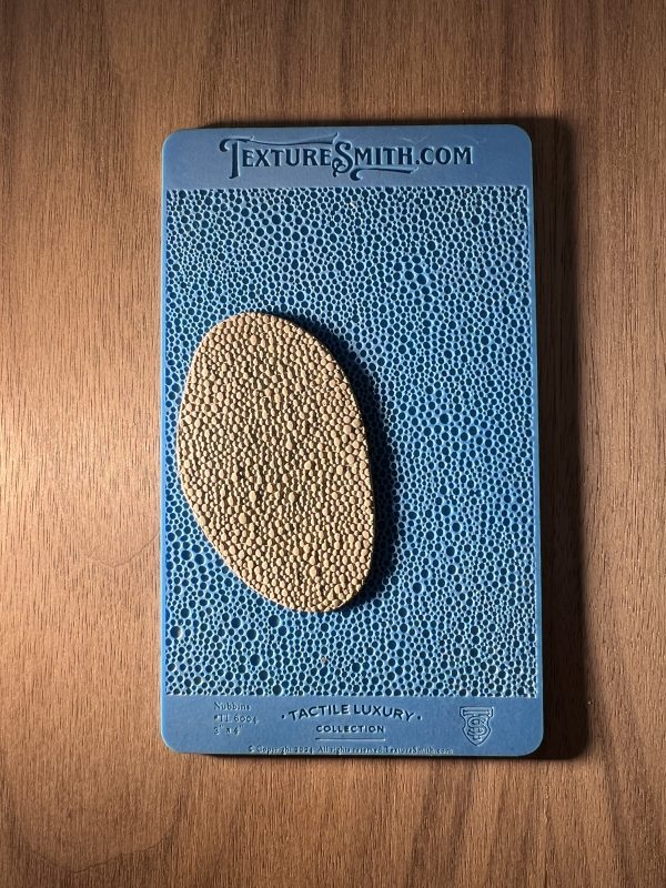 Blue and beige textured sample on wood.