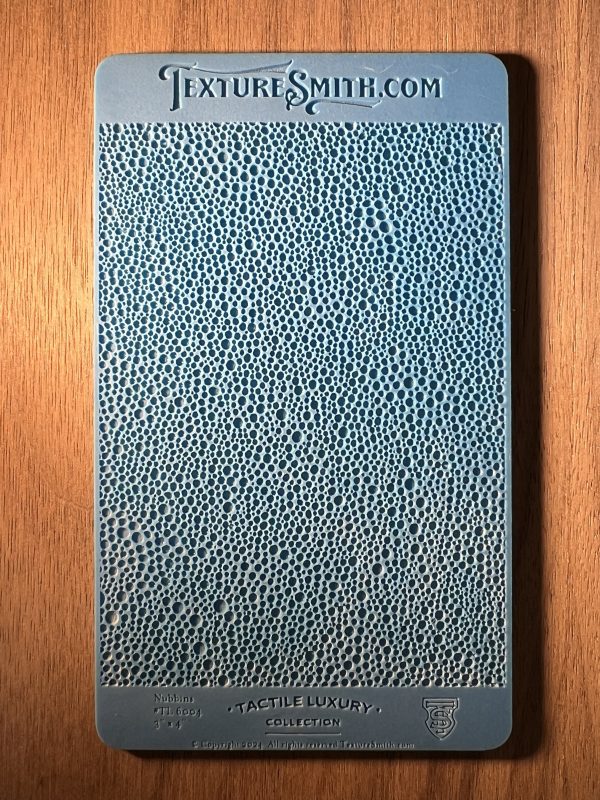 Blue textured sample on wooden surface.