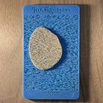 Textured stone on blue textured background.