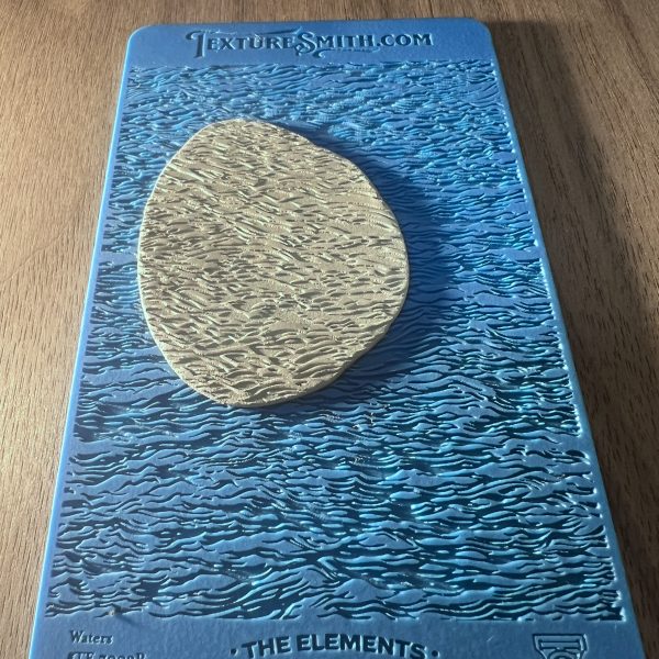 Textured clay on blue textured background.