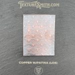 Copper patina texture sample with decorative pattern.