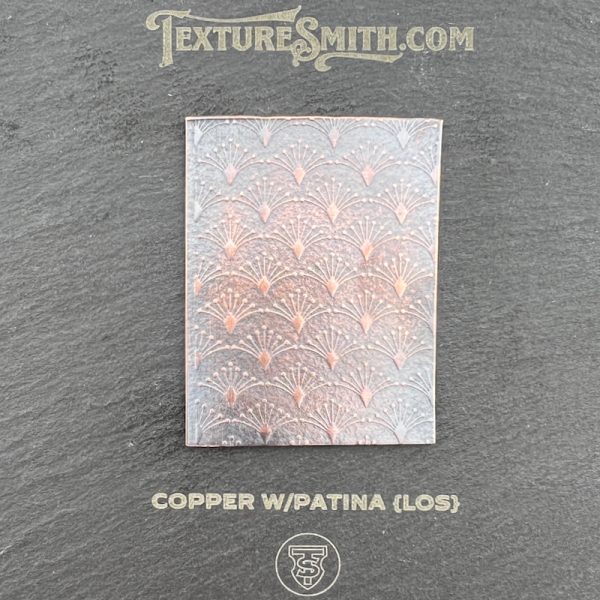 Copper patina texture sample with decorative pattern.