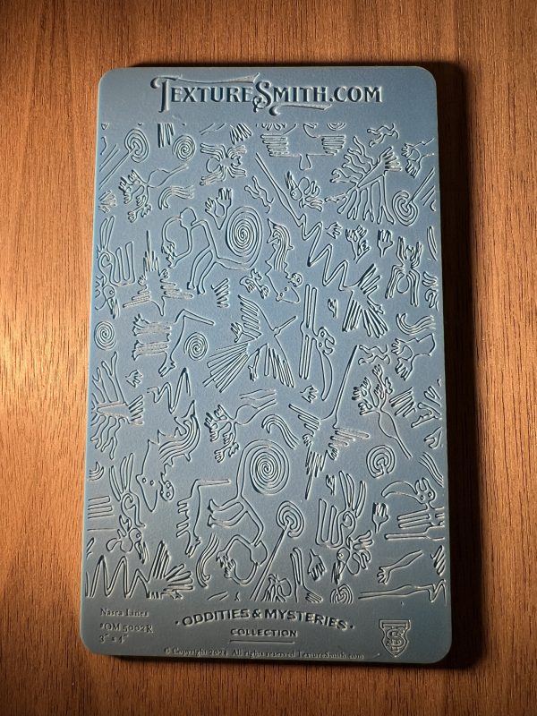Textured blue mold with abstract designs.
