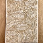 Intricate leaf pattern on textured card.