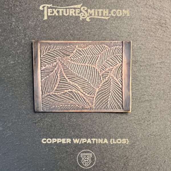 Copper patina texture with engraved leaf pattern.
