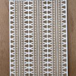 Antique-style textured stencil on wood background.