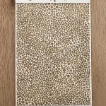Textured card with circular pattern design.