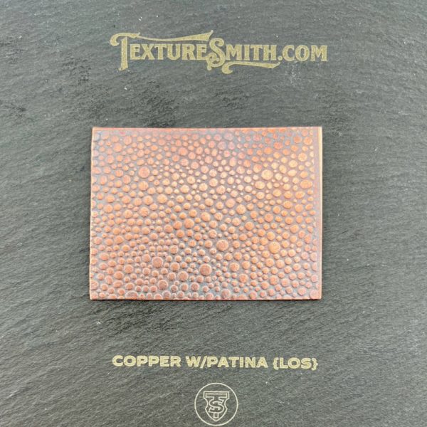 Copper sheet with textured patina finish.