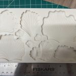 Leaf-shaped silicone mold on cutting mat.