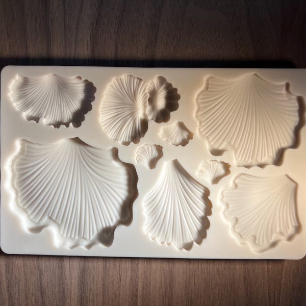 Ginkgo leaf-shaped silicone mold on table.