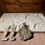 Shell molds and textured metal pieces displayed.
