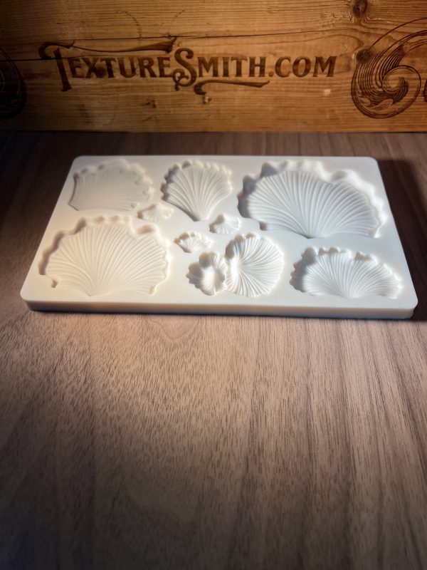 Silicone mold with shell designs on wood.