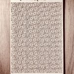 Swirl pattern texture on wooden background.
