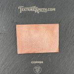 Copper texture sample on black background.