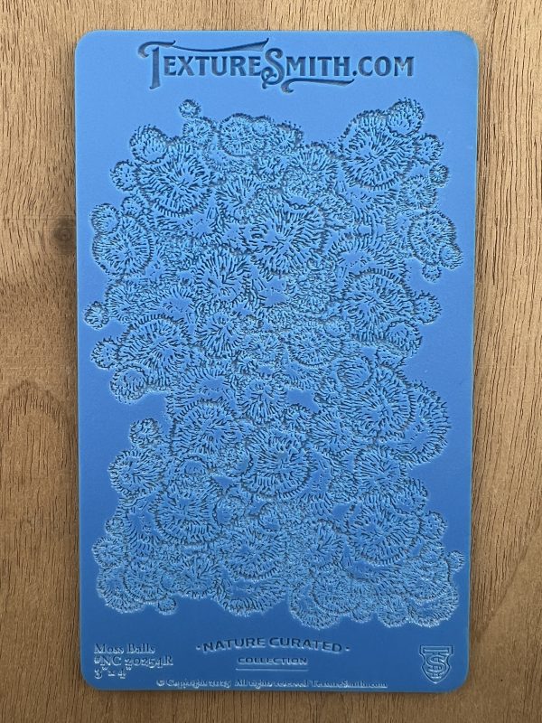 Blue textured stencil on wooden surface.