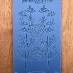 Blue floral texture mat on wooden surface.