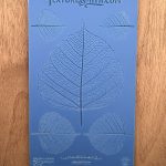 Blue leaf texture mold on wooden surface.