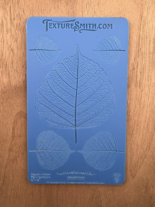 Blue leaf texture mold on wooden surface.