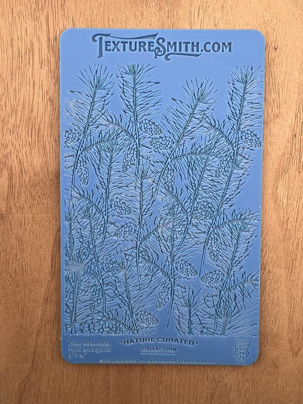 Blue textured sheet with pine branch design.