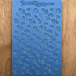 Blue stencil with leaf pattern design.