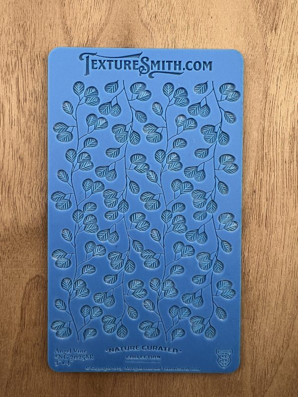 Blue stencil with leaf pattern design.