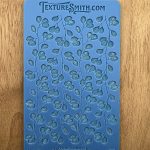 Blue leaf-patterned silicone texture mat.