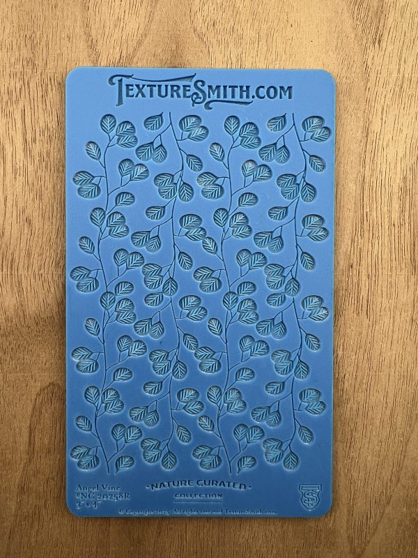 Blue leaf-patterned silicone texture mat.