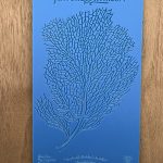 Blue stencil with intricate branching pattern.