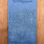 Blue embossing mat with tree design.