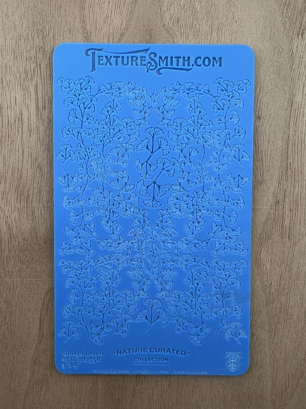 Blue embossed texture sheet with floral design.