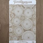Textured card with circular dot patterns.