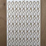 Textured worm pattern on rectangular card.