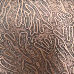 Brown abstract textured pattern on surface.