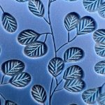 Embossed blue pattern with leaf design.