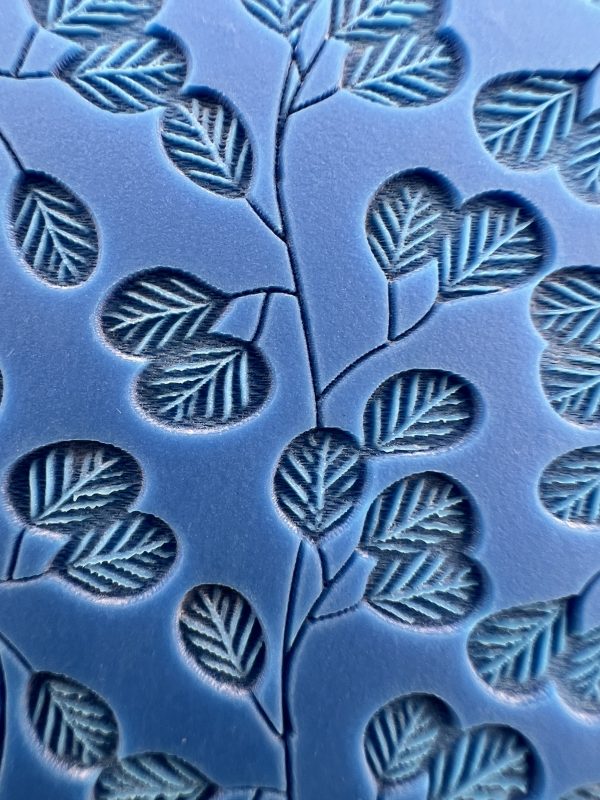 Embossed blue pattern with leaf design.