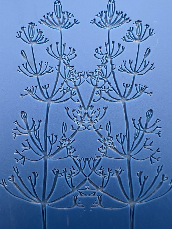 Embossed floral pattern on blue background.