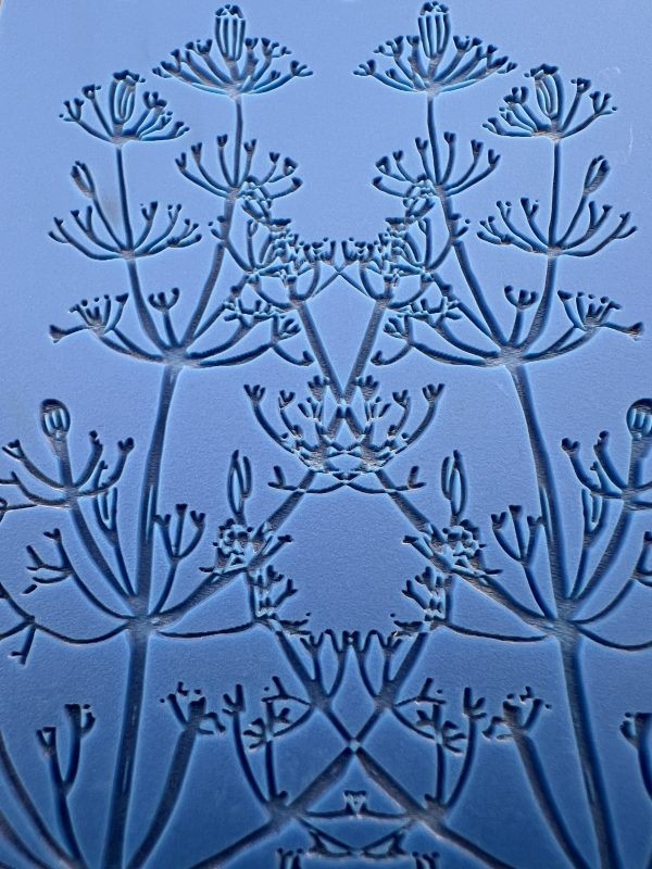 Blue floral pattern with symmetrical abstract design.
