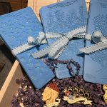 Blue textured cards with decorative pins displayed.