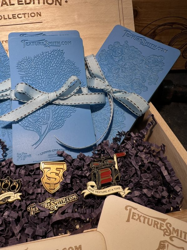 Blue booklets and pins in a wooden box.