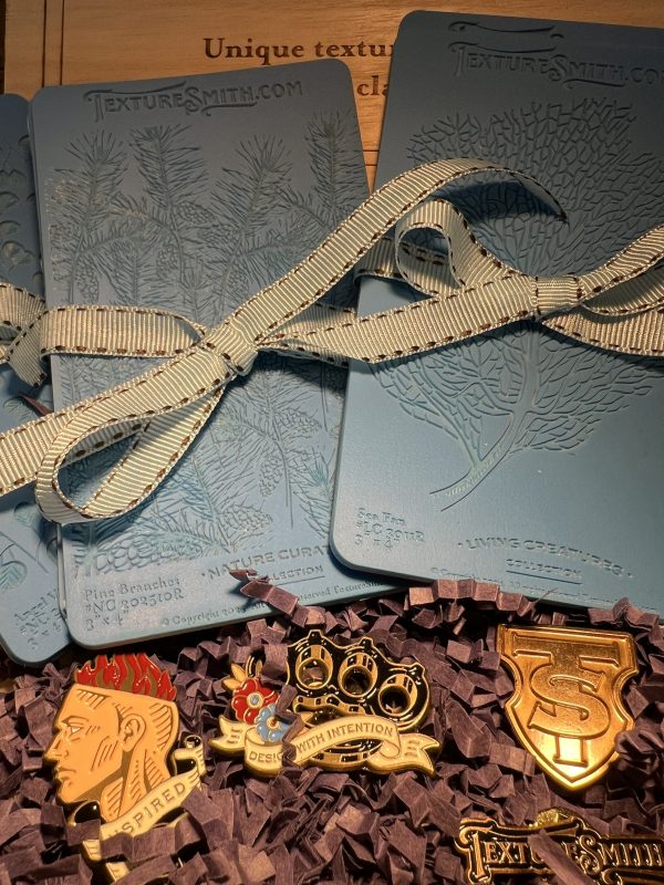 Embossing stencils with decorative pins and ribbon.
