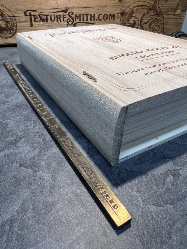 Wooden box and ruler on gray surface.